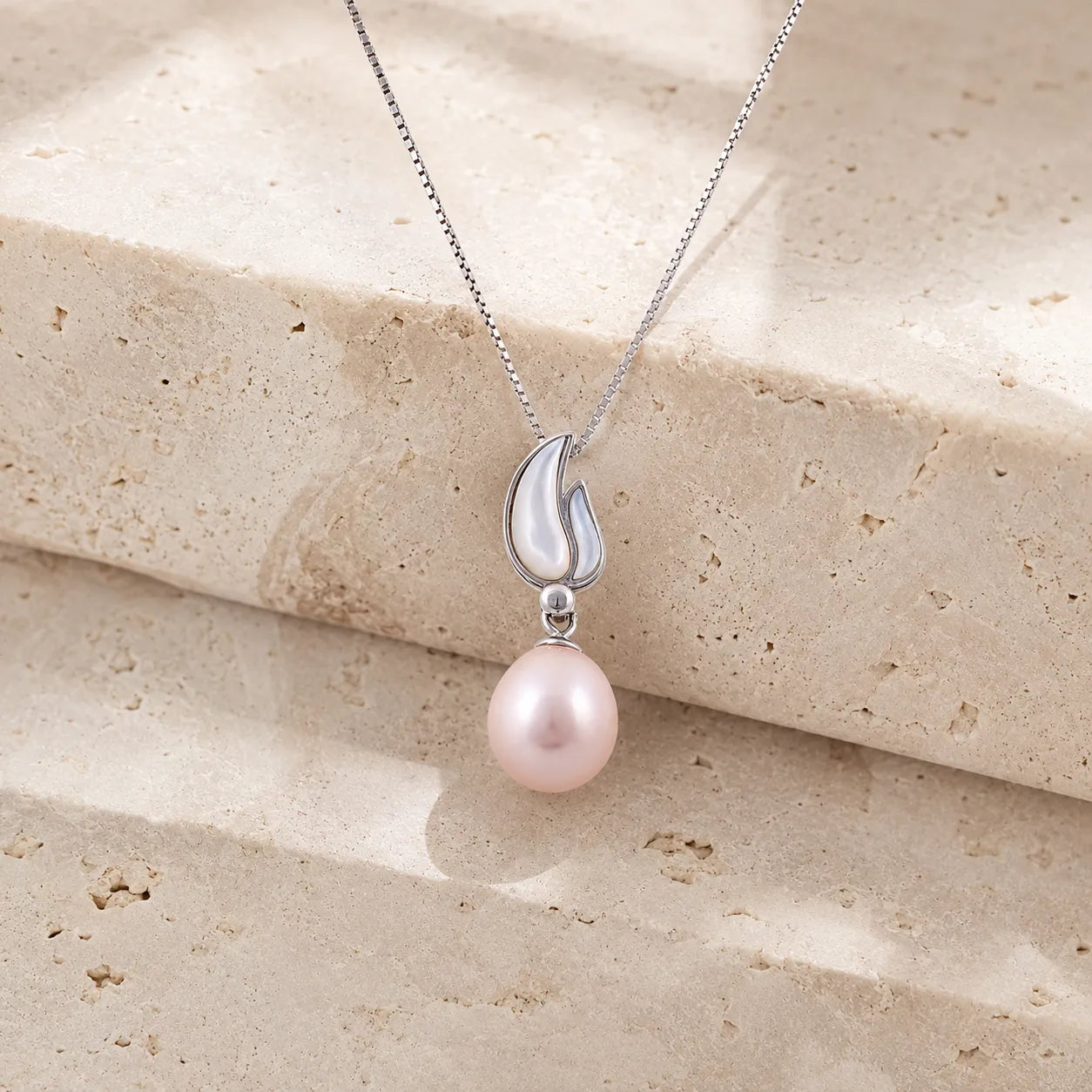Delicate Pink Pearl Pendant in a Silver Tulip Petal Setting