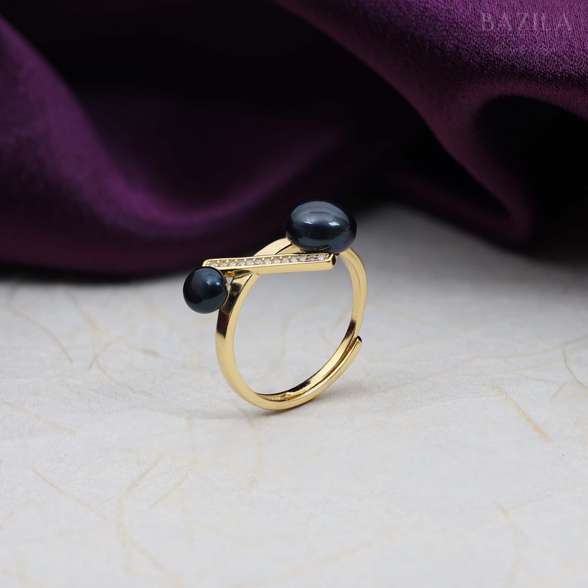Gold Ring with Dual Black Pearls and Crystal Bar Design